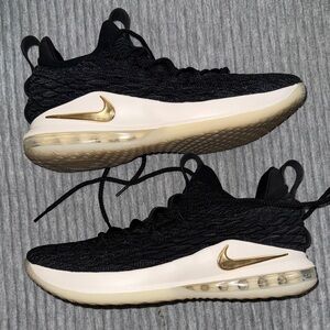 Nike LeBron 15 Low in the Black/Metallic Gold/Phantom colorway.